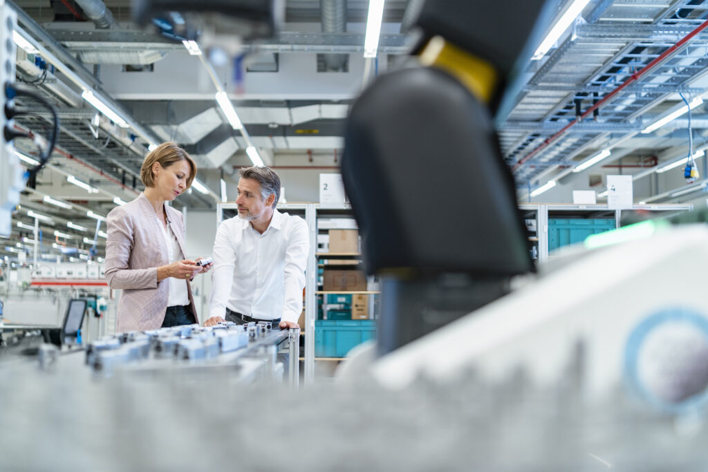 Headhunter in Hessen sprich mit Kunden in moderner Fabrik